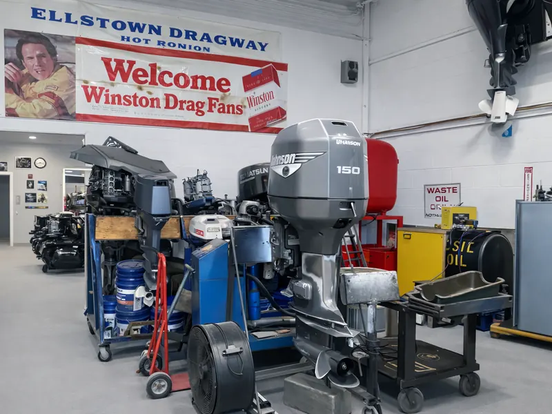 Outboard motors and rebuilt marine engines on the PK Marine Service shop floor in Bristol, Rhode Island